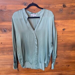 Light green/teal silky blouse.